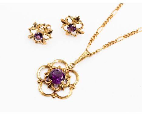 An amethyst pendant with a floral design, set with a round amethyst to the centre, set in 14ct gold, along with a similar pai
