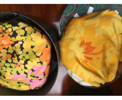 One burnt orange silk turban with brown/green pattern, made by Christian Dior (1960s/70s) and another yellow/pink abstract pa