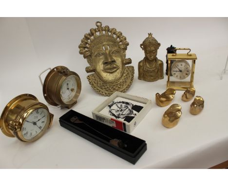 A small ships style barometer together with a similar clock, two brass African heads, a small carriage style clock and metalw
