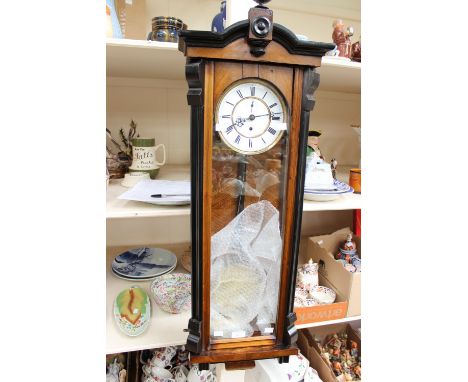 A 19th Century walnut cased Vienna wall clock, white chapter dial and black Roman numerals with a single weight