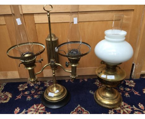 A brass twin burner oil lamp; together with a brass oil lamp with white shade (2) 