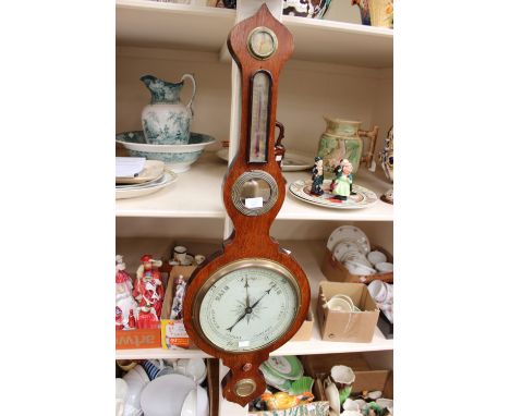 An oak cased banjo barometer with thermometer and humidity gauge 