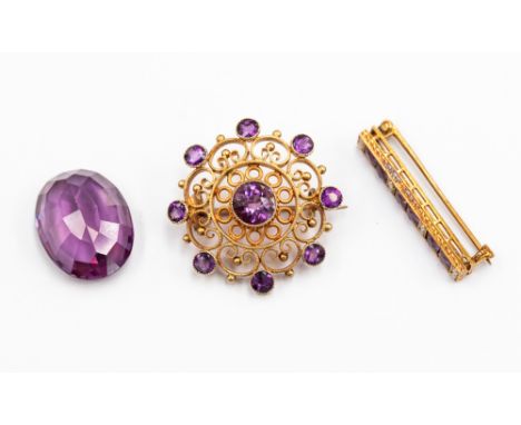 A Victorian 9ct gold Etruscan style brooch set with amethyst, open scroll work design set with nine round amethysts,  along w