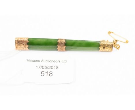A jade and gold mounted brooch 