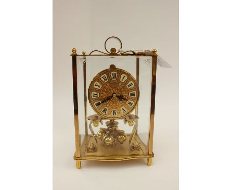 A brass Kundo anniversary clock 