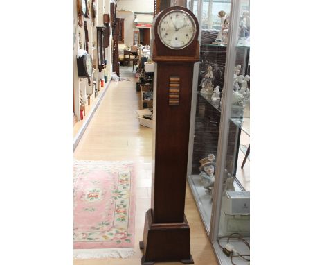An early 20th Century oak Grandmother clock, having an eight day movement, the silvered dial with three winder holes