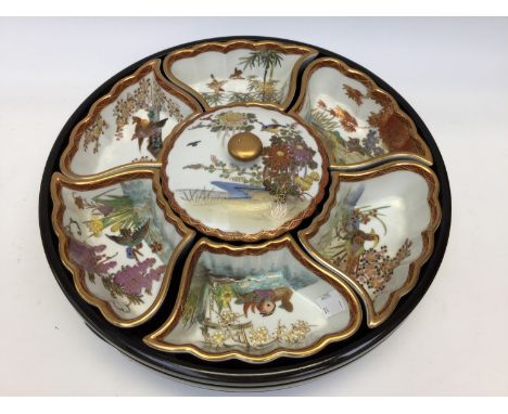 An oriental lazy Susan with ceramic dishes with oriental scenes (1)