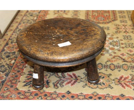 A small oak four leg stool