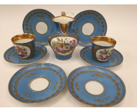 A Sevres style porcelain jug and matching cups and saucers, each painted with floral vignettes on Sevres style blue ground, p