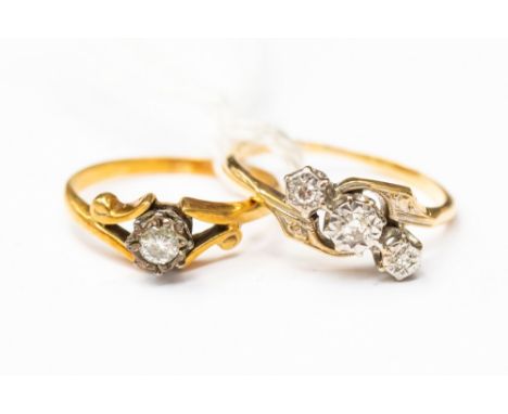 Two 18ct gold and diamond rings, one with a cross over design illusion set with three diamonds, engraved shoulders, along wit