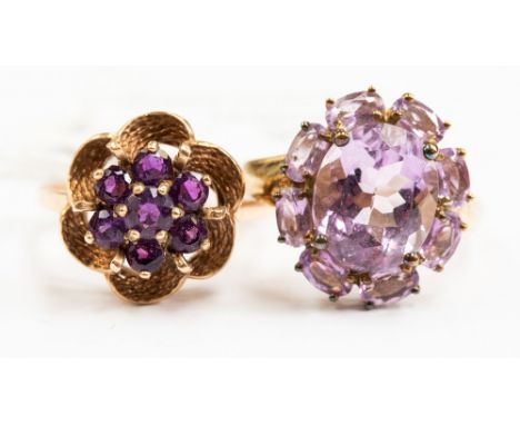 Two 9ct gold and amethyst dress rings, both with floral designs, sizes R and Q½, with a combined total gross weight of approx