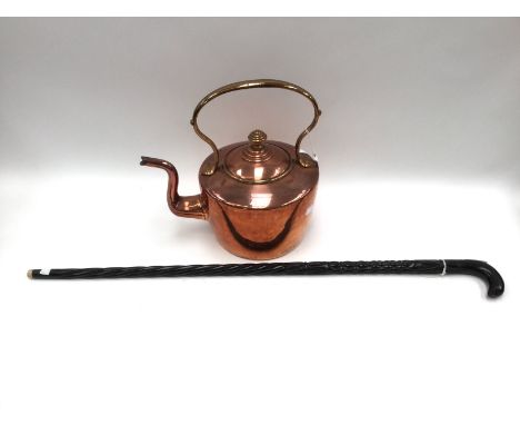A copper kettle and an ebonised carved walking stick (2) 