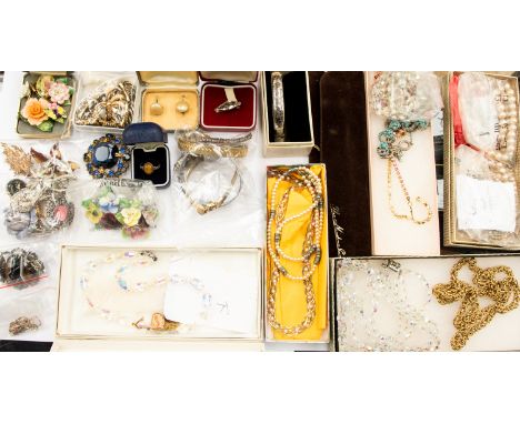 A collection of costume jewellery to include a silver bangle, a silver and tigers eye ring, silver onyx brooch, a silver char