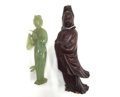 A Jade figurine (af) with stand; together with a carved wooden deity (2) 