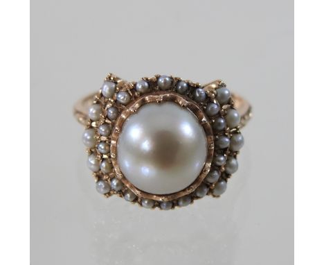 A 14 carat ladies pearl cluster ring, set with graduated rows of pearls, boxed