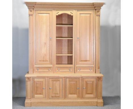 A Clive Christian light oak side cabinet, of large proportions, with a dentil moulded cornice, maple lined and fitted with ad