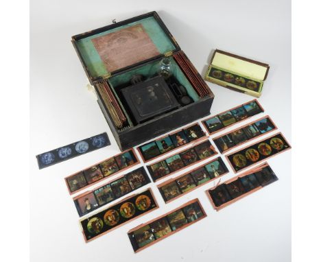 A vintage magic lantern, cased, 30cm, together with various slides