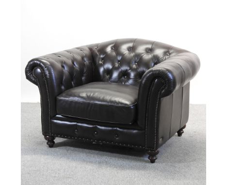 A large dark brown leather upholstered button back armchair, bearing a label for Cindy Crawford Home