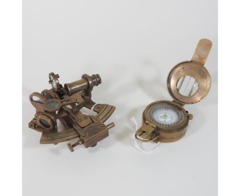 A reproduction metal pocket sextant, together with a compass