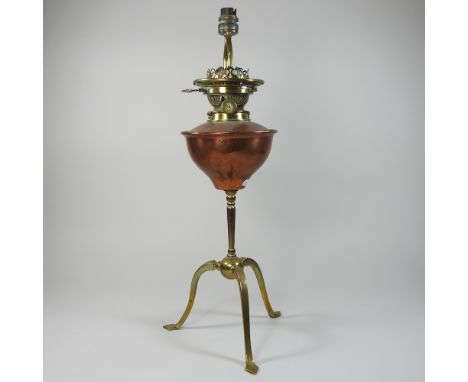 An early 20th century Arts and Crafts brass and copper oil lamp, in the manner of WAS Benson, 54cm high