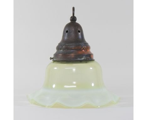 An early 20th century vaseline green glass light shade, of frilled shape, with a brass mount, 30cm diameter