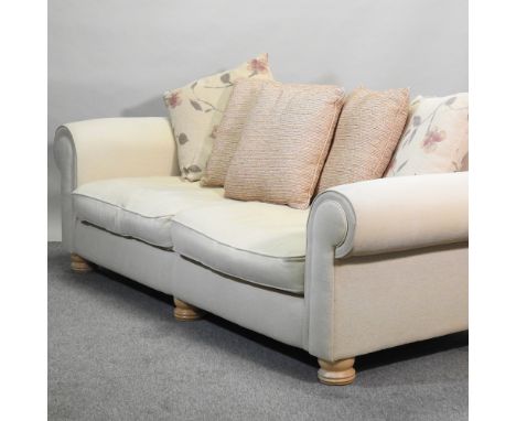 A modern cream upholstered sofa, with loose cushions, 228cm