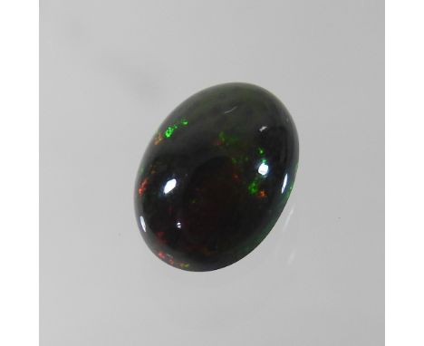 An unmounted black opal, approximately 2.54 carats, with certificate