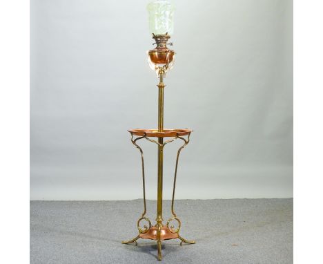 An ornate Arts and Crafts copper and brass telescopic standard lamp, in the manner of WAS Benson, with an opaline glass shade