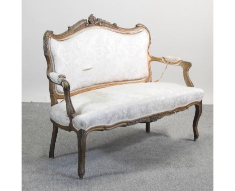 A carved gilt painted and cream upholstered show frame sofa, 132cm