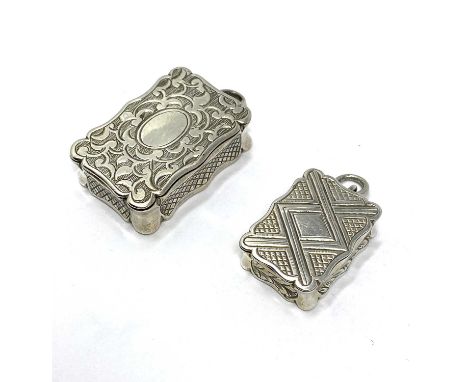 TWO VICTORIAN SILVER PENDENT VESTA CASES, ASTON & SON, BIRMINGHAM, 1857 / 58 both shaped rectangular box form and hinged to s