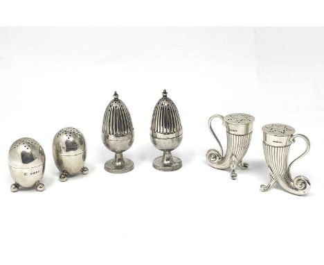 THREE PAIRS OF VICTORIAN SILVER PEPPERETTES all with gilt interiors: one pair plain egg form, on three ball feet and with sim