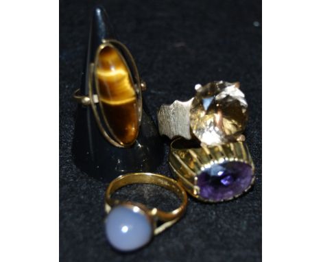 Rings - a tigers eye dress ring, yellow metal mount;  others amethyst. smoky quartz, part stamped 585, 22.3g gross (4)