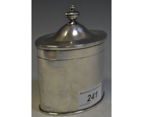 A silver shell bowl caddy spoon, London 1935;  a white metal tea caddy (2)