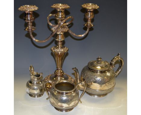 A James Dixon and Son silver plated three piece tea service; a Sheffield plate candelabra (4)