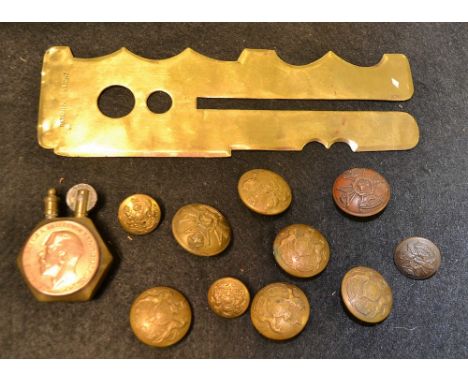 A Trench Art lighter; military buttons and button polishing aids