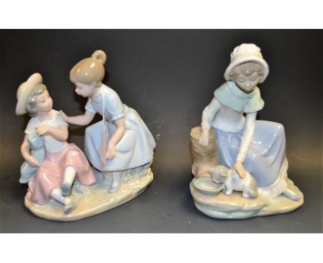 A Nao, Spanish porcelain figure group, girl with kitten, 8cm, printed mark; another Nao figure, Playing Baby, 8cm, printed ma