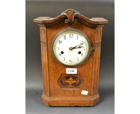 An Edwardian oak cased inlaid mantel clock