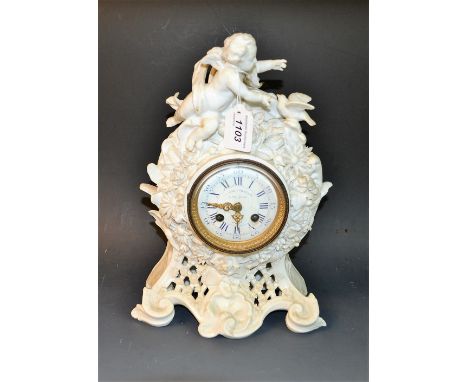 A late Victorian porcelain mantel clock, Howell James & Co, To The Queen, London, the scrolling Rococo case surmounted with a