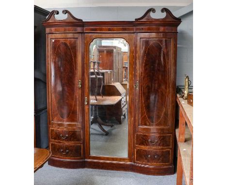 A Victorian double wardrobe with a central mirror with bow doors and string inlay and drawers with scroll pediment etc, 195cm