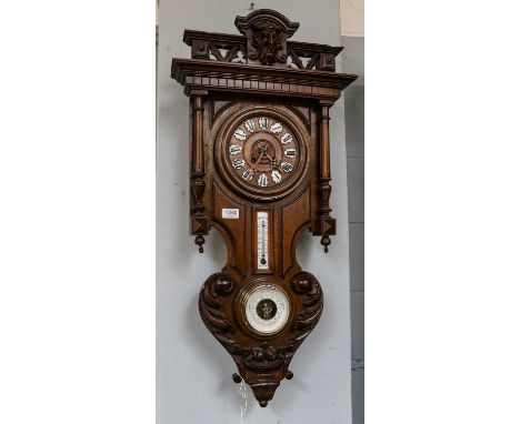 A striking wall clock circa 1890, the case with thermometer tube and aneroid barometer, the twin barrel movement striking on 