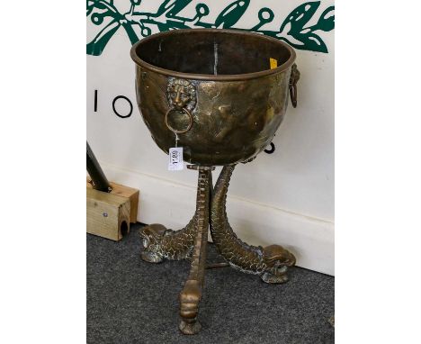 A pair of 19th-century Dutch brass planters, each with three-ring and lion mask handles, raised on three dolphin-form legs, 4
