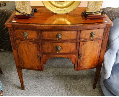 A George III cross banded and inlaid mahogany sideboard with bow from and of small proportions, 101cm by 56cm by 94cmTop badl