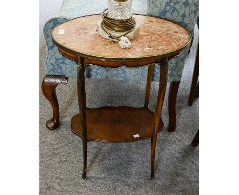 A French marble topped gilt metal mounted oval lamp table with shelf stretcher, 53cm by 35cm by 72cm