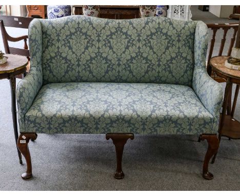 A Queen Anne style two-seater sofa upholstered in floral damask + (cover), 133cmBoth rear legs repaired, wings and the back w