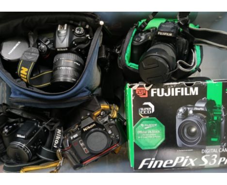 A box of cameras and accessories including Fuji Finepix S3 Pro camera, Niko D7100 camera, Nikon F501, Nikon Coolpix L840, cam