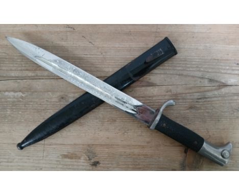 A German WWII K98 parade bayonet with etched blade and metal scabbard, the blade etched on one side only.&nbsp;