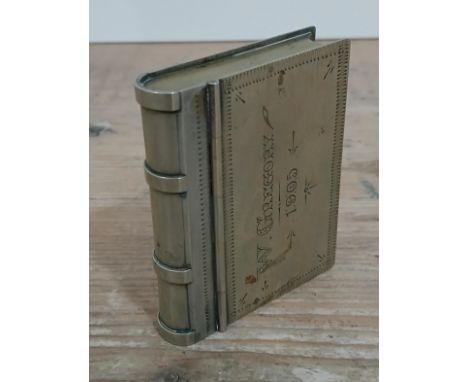 A white metal snuff box in the form of a book, engraved for 1905, length 7cm.