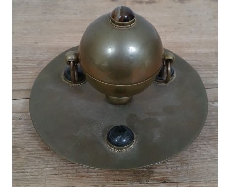 An Arts &amp; Crafts style brass inkwell with hardstone cabochons, diameter 15.5cm.