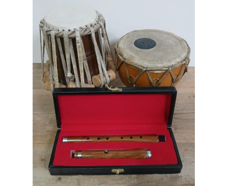 Two skin drums and a wooden flute. 