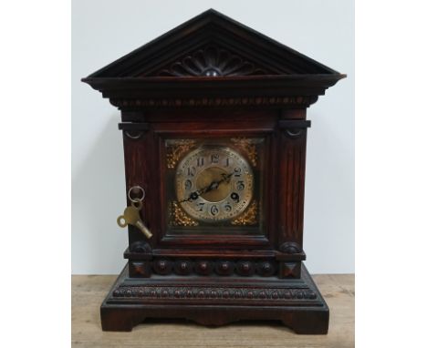 A German architectural mantle clock, height 40cm. Condition- some general wear/slight marks to the case, pendulum is present,